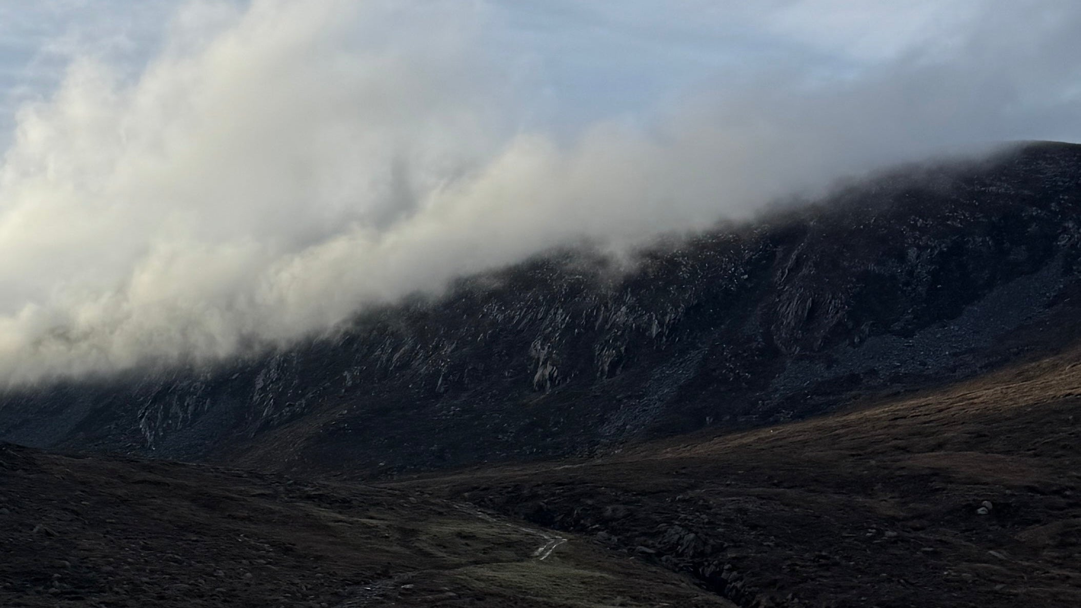 Mountain landscape with clouds rolling over the peaks